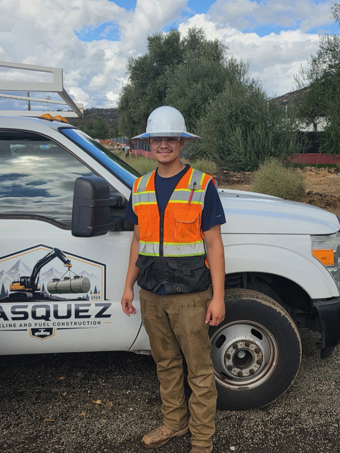 A Vasquez crew member beside the company service truck